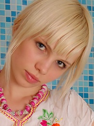 Blonde stripping in a bathroom